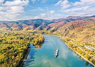 Beeindruckende Donaulandschaft, Beeindruckende Donaulandschaft mit herbstlichen Hügeln und Fluss.