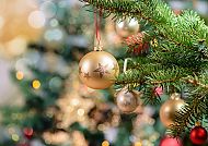 Weihnachten, Glänzende Weihnachtskugel an einem festlich geschmückten Tannenbaum., Weihnachtliche Kugeln am Tannenbaum, festliche Atmosphäre.